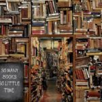 A wall of books at varying angles. A chalkboard sign reads "So many books, so little time"